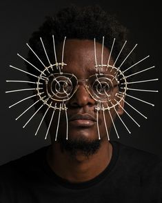 a man wearing glasses with spikes on his face and the eyes are made out of wire