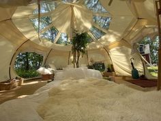 a large bed sitting inside of a white tent