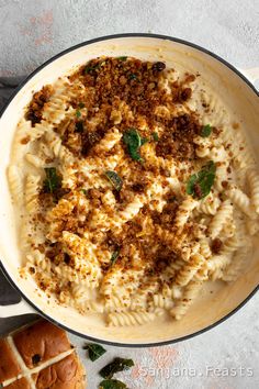 a pan filled with pasta and meat on top of a table