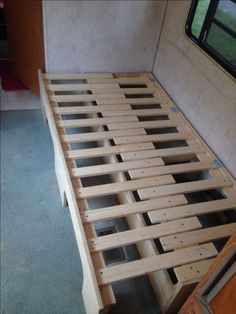 the bed frame is made up and ready to be used as a headboard for a camper