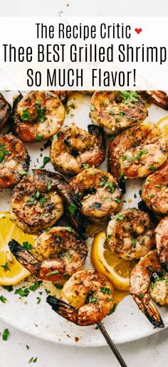 grilled shrimp on a plate with lemon wedges and parsley garnish