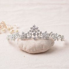 a tiara sitting on top of a white pillow