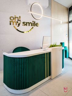 an office with a green and white reception desk