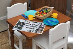 a wooden table topped with plates and cups filled with candy next to a basket of candies