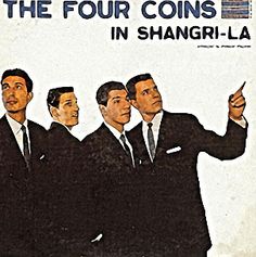 four men in suits are pointing at something on the side of a sign that says,'the four coins in shanri - la '