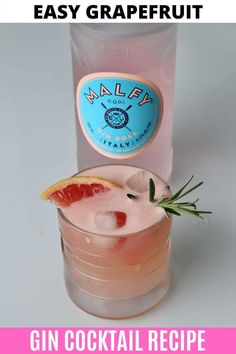 a gin cocktail with grapefruit and rosemary garnish