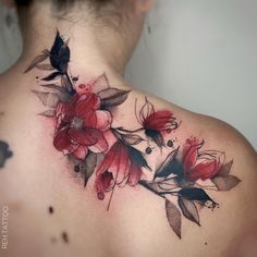 the back of a woman's neck with red flowers on her upper and lower part