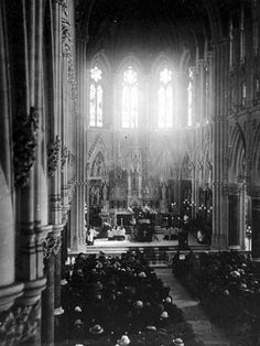 an old black and white photo of people in a church looking at the altars