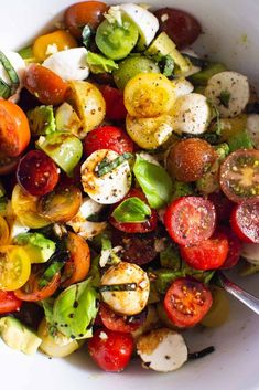 a white bowl filled with lots of different types of vegetables