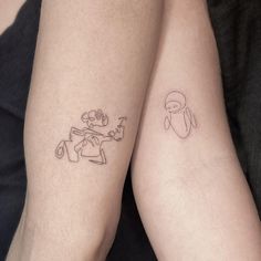 two people with matching tattoos on their legs, one has a penguin and the other has a ghost