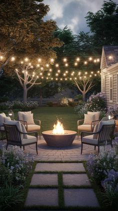 an outdoor fire pit surrounded by chairs and lights