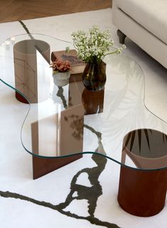 a glass table sitting on top of a white rug