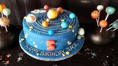 a birthday cake decorated with planets and stars