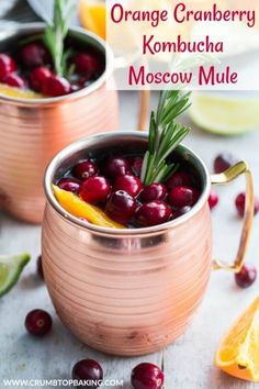 orange cranberry kombucha moscow mule in copper mugs with garnish