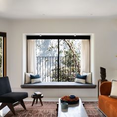 a living room filled with furniture and a large window