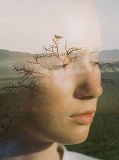 a man with his head in the air and trees growing out of his face