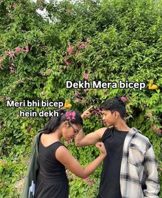 two people standing next to each other in front of bushes and flowers with the words deh mera bicep mein hain dek