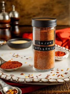 a table topped with bowls and spoons filled with spices