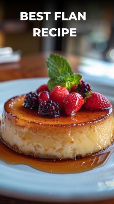 a white plate topped with a dessert covered in syrup and fresh berries on top of it