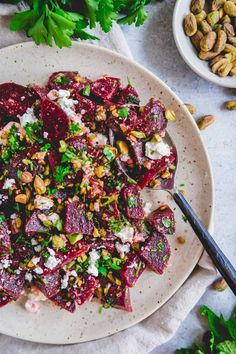 beet salad with nuts and feta cheese on a white plate