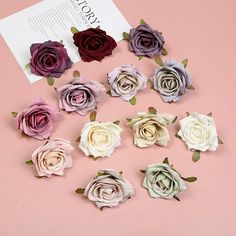 the paper flowers are arranged in different colors