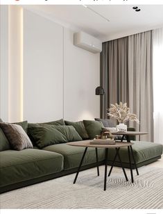 a living room with a large green couch and coffee table in front of the window