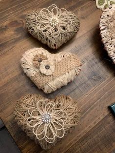 three heart shaped baskets sitting on top of a wooden table