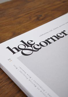 a close up of a book on top of a wooden table with the title hole & corner