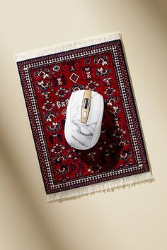 a computer mouse sitting on top of a rug