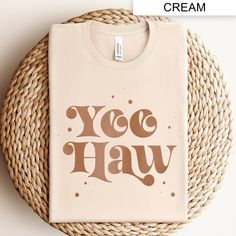 Embrace the classic cowboy spirit with our "Yee Haw" Western Cowboy Shirt. Perfect for country music lovers and southern style enthusiasts, this vintage-inspired tee features a rustic "Yee Haw" graphic, blending modern design with retro charm. Ideal for rodeo events, concerts, or casual outings, this shirt brings a touch of the wild west to your everyday wardrobe. Show off your love for country western themes with this unique and stylish t-shirt. Rodeo Tshirt, Boy Western, Cowboy Graphic, Retro Cowboy, Rodeo Events, Classic Cowboy, Rodeo Shirts, Cowboy Shirt, Far West