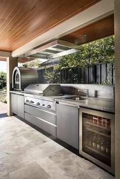 an outdoor kitchen with stainless steel appliances