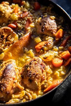 chicken and rice dish with carrots in a skillet