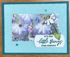 a close up of a greeting card with flowers on the front and blue background, it's the little things that matter