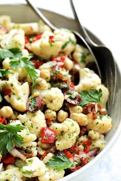 a bowl filled with pasta and garnished with parsley