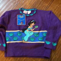 Vintage The Disney Store Princess Jasmine From Aladdin Sweater Sweater Material With Appliqu Of Jasmine Embroidered On Front And Sleeve Detail! Excellent Gently Used Condition With Very Mild Piling. Vibrant Purple Color. A Great Rare Find! Also A Razzazzles Aladdin Jasmine Necklace By Applause To Wear With It! Complete This 90s Look With Another Original! New In Package Condition Collectible!