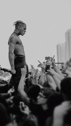 a man standing on top of a stage surrounded by people