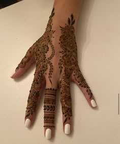 a woman's hand with henna on it