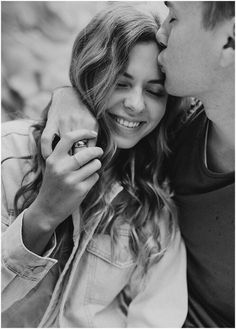 black and white photograph of a man kissing a woman's forehead on the cheek