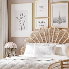 a white bed topped with pillows and pictures