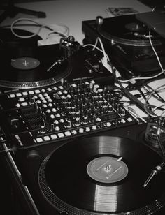 black and white photo of two turntables with vinyl