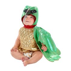 a baby in a costume sitting on the ground