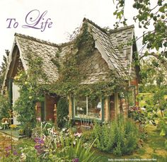 a small house is surrounded by flowers and greenery