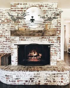 a living room with a fire place in the center and a mirror on the wall above it