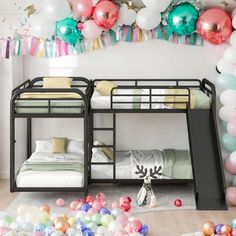 two bunk beds are surrounded by balloons and streamers