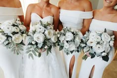 four bridesmaids in white dresses holding bouquets