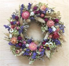 a wreath made out of dried flowers on a table