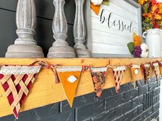 a mantle decorated with fall decorations and bunting