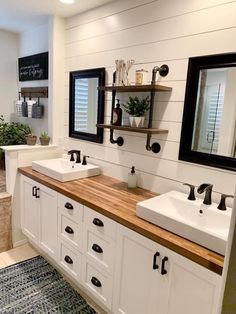 a bathroom with two sinks, mirrors and shelves on the wall next to each other