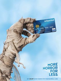 a card stuck in the palm of a tree that says more horror for less on it