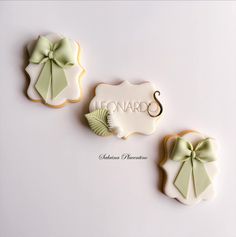 three decorated cookies with bows and the word lemonard's written on one cookie